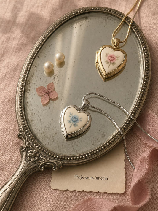 Gold and silver floral heart lockets on an antique hand mirror