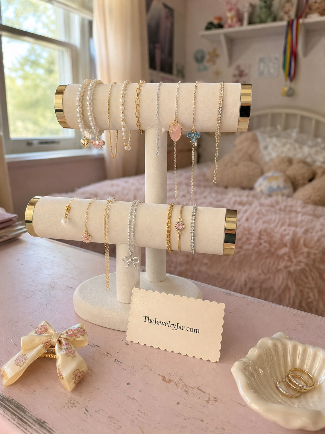 Cream velvet jewelry stand styled with necklaces and bracelets