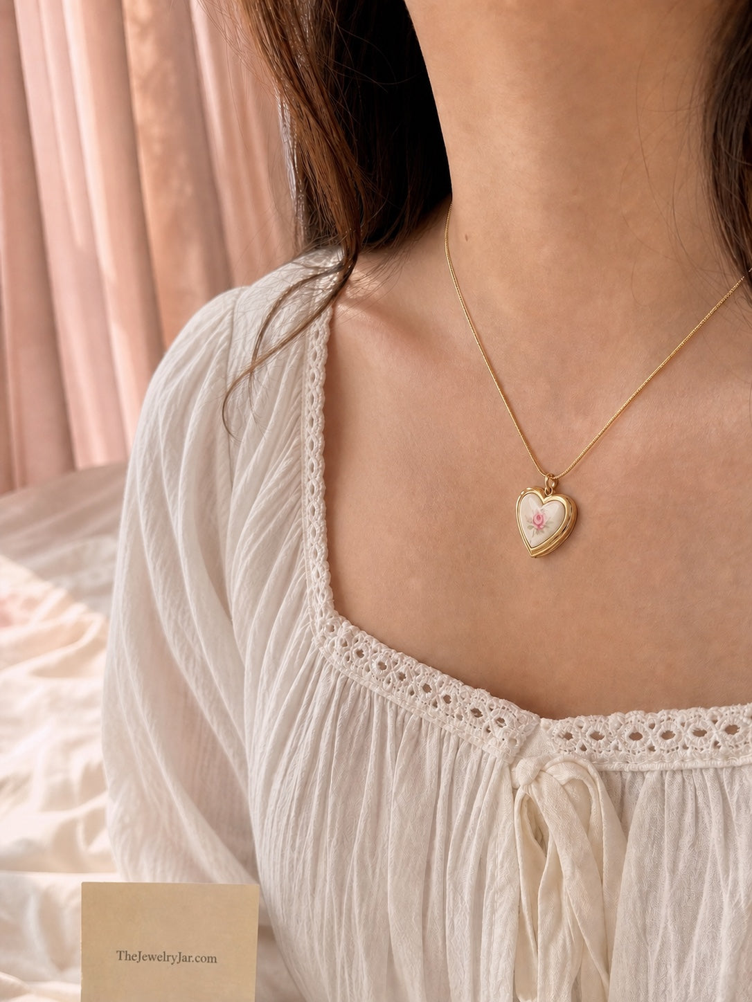Gold floral heart locket worn with cream blouse