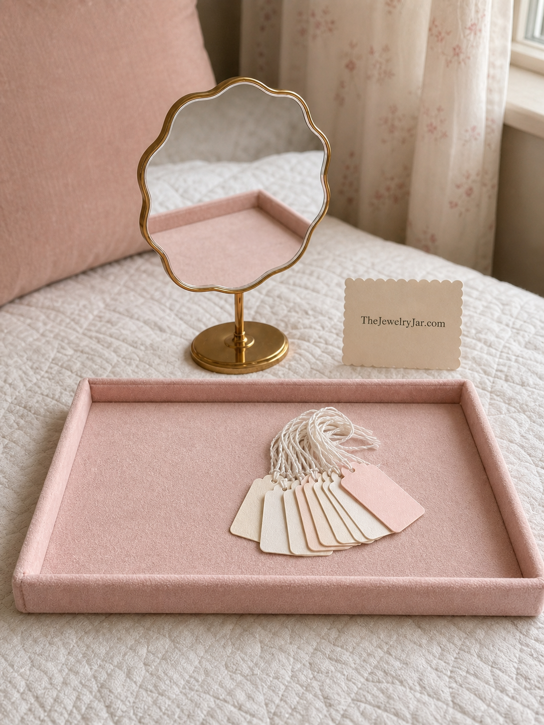 What's included: blush velvet tray, small gold wavy mirror and 20 tags with string